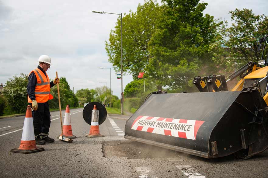 Workman repairing road