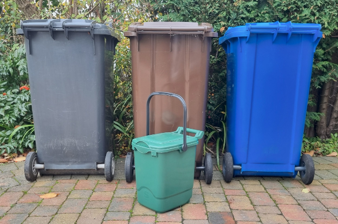 Full set of household waste bins used in Derby, including black bin, brown bin, blue bin and new green food waste bin.